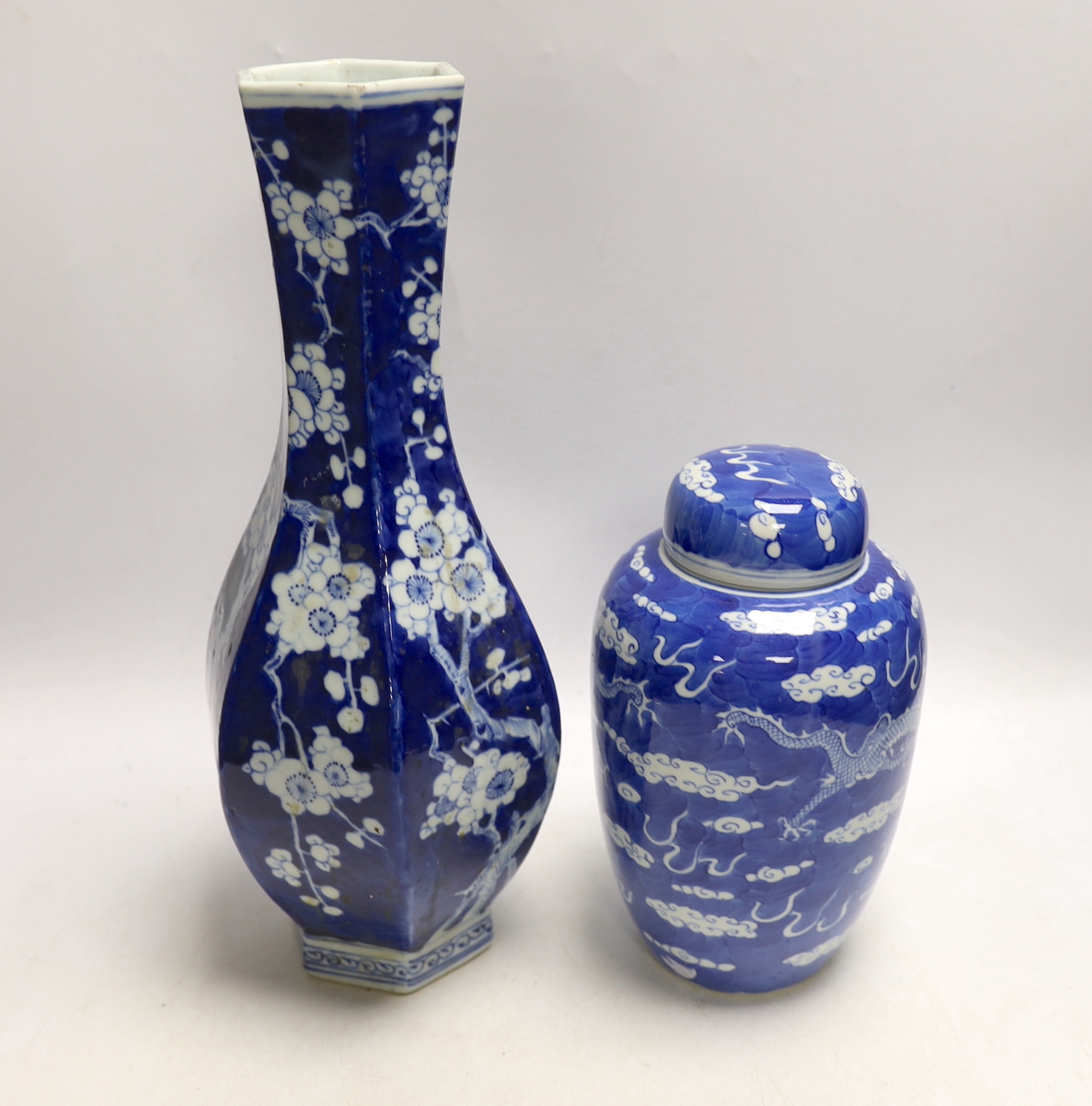 A Chinese blue and white hexagonal baluster vase, Qianlong mark, 19th century and a blue and white ‘dragon’ jar and cover, 19th century, tallest 36cm (2)